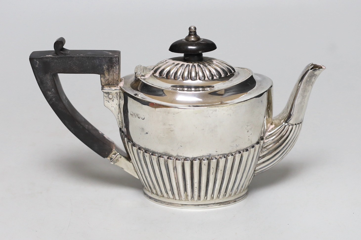 A late Victorian demi-fluted silver bachelor's teapot, London, 1885, gross weight 8.3oz.